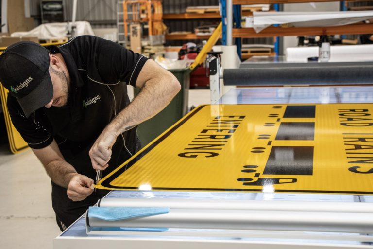 Kalsigns worker preparing a road sign in a workshop